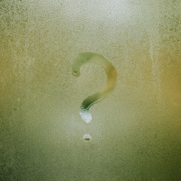 A question mark with yellow-ish ragged background