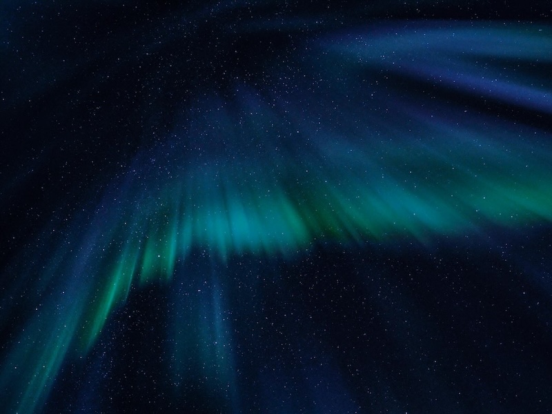 Abstract blue light suggesting ethereal wings—spiritual, spacious, and quiet.